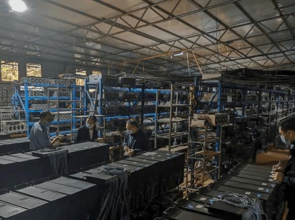 Miners inspecting a mining farm, showcasing the scale of operations.